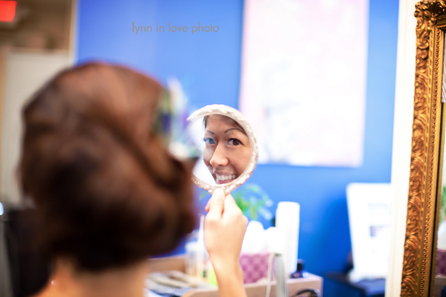 bride looking into the mirror and smiles