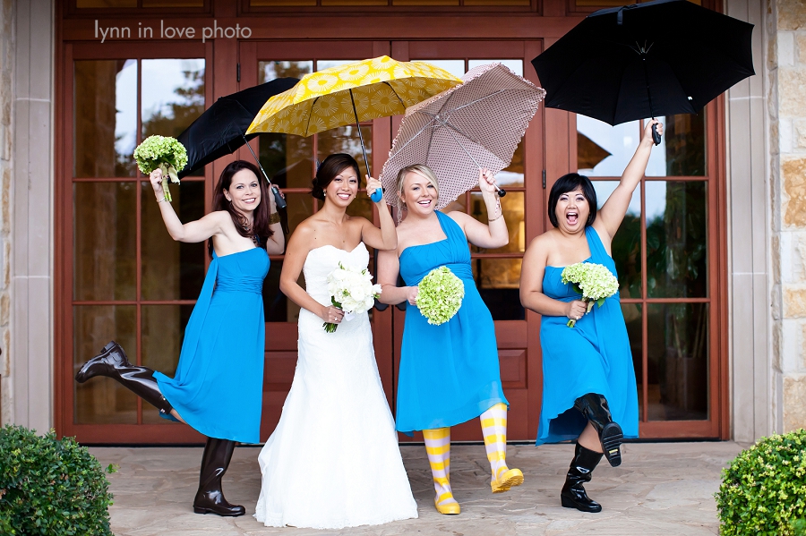 Rainy day bridal party in rainboots and umbrellas