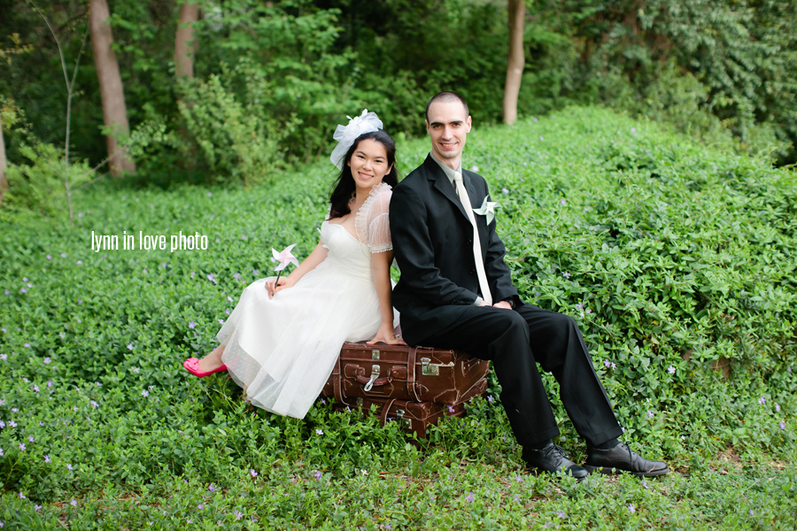 Minh and Thomas's Retro Vintage Bride + groom session in a lush green Dallas Park on grandmother's vintage suitcase by Lynn in Love Photo, Dallas Wedding Photographer