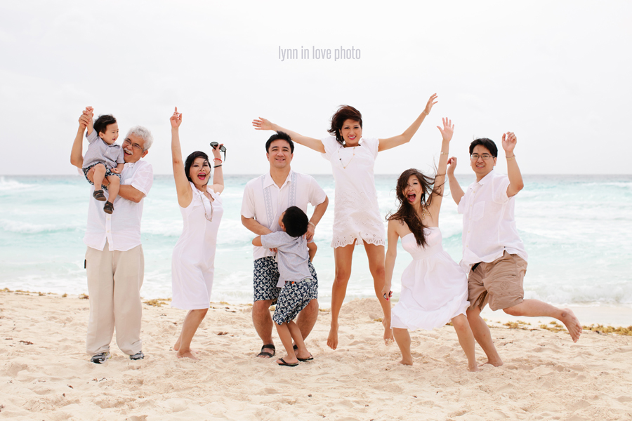 Asian family portraits on the beach jumping in white outfits in Cancun, Mexico, by Lynn in Love Photo, Dallas Family Photographer