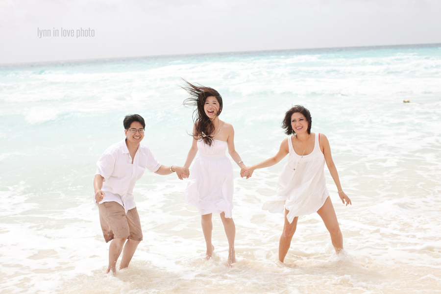 Asian family portraits on the beach in white outfits in Cancun, Mexico, by Lynn in Love Photo, Dallas Family Photographer
