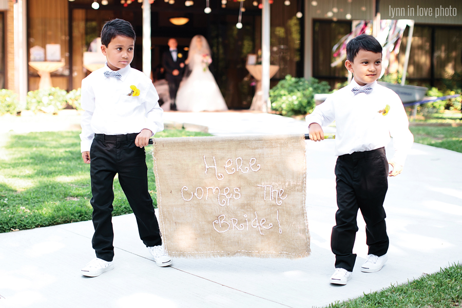 Gabi and Oscar's Vintage Glam Outdoor Wedding with cute details like flower boys with here comes the bride banner by Lynn in Love Photo, Dallas Wedding Photographer