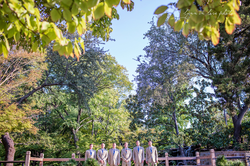 Lanchi and Todd's Rice University and Denver Bronco themed wedding with groomsmen bridal party picture in blue dresses at the Ft. Worth Japanese Gardens by Lynn in Love Photo, Dallas Wedding Photographer