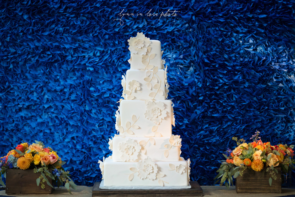Lanchi and Todd's Rice University and Denver Bronco themed wedding with colorful blue and orange details with owls during reception with gorgeous white tiered cake by sugarbee sweets at the Ft. Worth Japanese Gardens by Lynn in Love Photo, Dallas Wedding Photographer