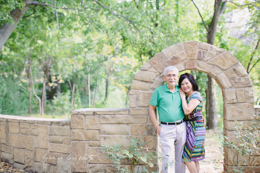 Mom and Dad Holiday Love Shoot at outdoor studio with stone bridge and colorful outfits by Lynn in Love Photographer, Dallas Ft. Worth Portrait Photographer
