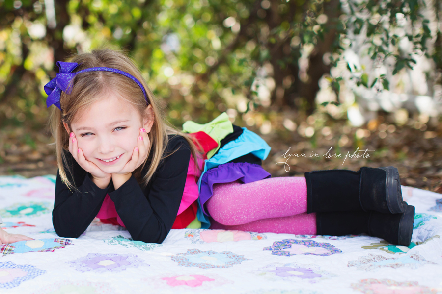 Colorful 7 year old girl with cute rainbow bright dress and pink sparkly tights by Lynn in Love Photo, Dallas and Houston Child photographer