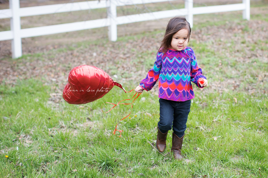 Mia, Kristin, and Carlos's Valentine session in bright colors (red and pink) at the outdoor studio by Lynn in Love Photo, Dallas and Houston Family and children photographer